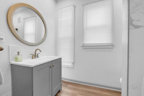 a bathroom with a sink and a mirror at Detroit 3BR in Mexicantown | Sleeps 7 + WiFi in Detroit
