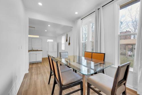 a dining room with a glass table and chairs at Detroit 3BR in Mexicantown | Sleeps 7 + WiFi in Detroit