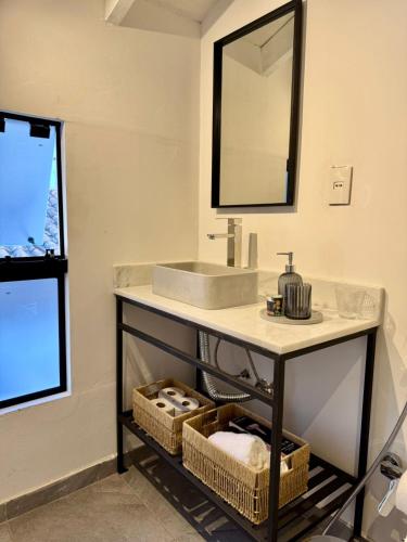 a bathroom with a sink and a mirror at Luxurious Quinta House in Fernando de la Mora
