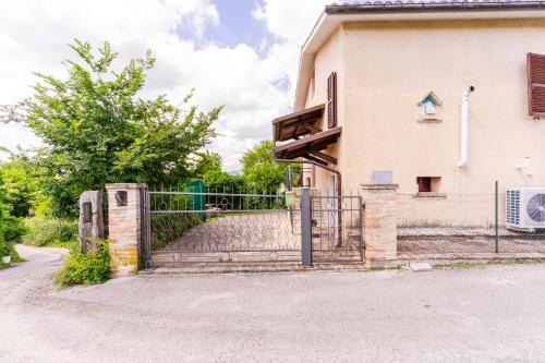 a gate to a house with a fence at house Al Cascinale in San Severino Marche