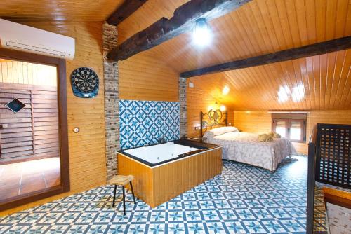 a bedroom with a bed in a wooden room at Cuencaloft Casa Rural Eloy in Carboneras de Guadazaón