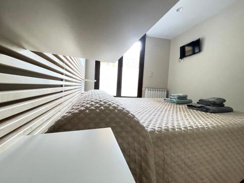 a bedroom with a bed and a large window at Lapaserina B in Arenas de Cabrales