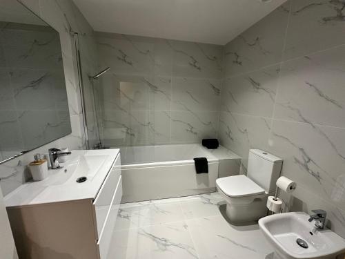 a bathroom with a tub and a toilet and a sink at Varandas do Gerês in Geres