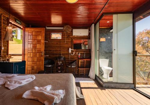 a room with a bed and a bathroom with a toilet at Pousada do Xerife in Caconde