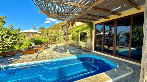 a swimming pool in the backyard of a house at Casa Obe in Yolina