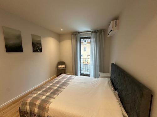 a bedroom with a bed and a window at Varandas do Gerês in Geres