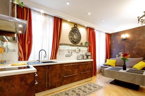 a kitchen with a large clock on the wall at BridgeStoneLuxApart Free Parking in Riga