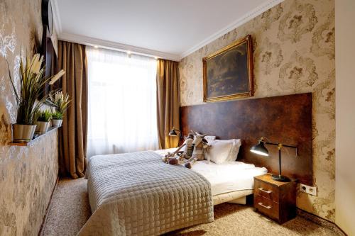 a bedroom with a bed and a window at BridgeStoneLuxApart Free Parking in Riga