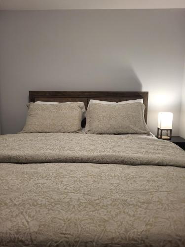 a bed with two pillows on top of it at Peace Home in Dieppe
