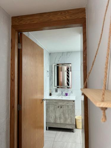 a bathroom with a sink and a mirror at Deluxe Loft Air Conditioning Downtown Parking in Tepatitlán de Morelos