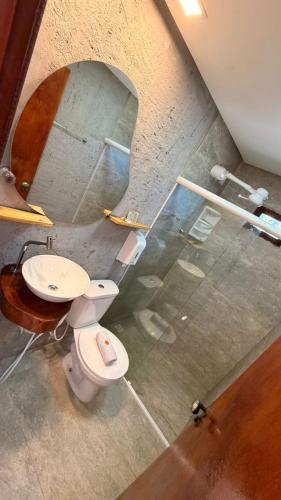 a bathroom with a toilet and a sink at Chalés Milagres Beach in São Miguel dos Milagres