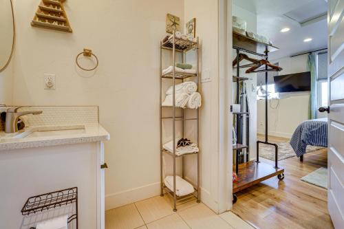 a bathroom with a sink and a shelf with towels at Dtwn Walkability! Grand Junction Couple's Retreat in Grand Junction