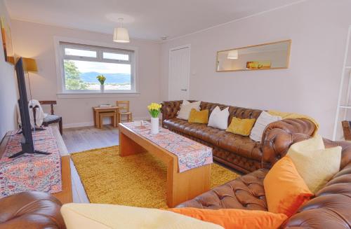 a living room with a couch and a coffee table at Stylish Stirling home with stunning views in Stirling
