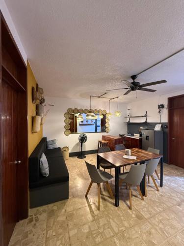 a living room with a table and a couch at HOSTAL CHOCOLATE CALENDA in Oaxaca City