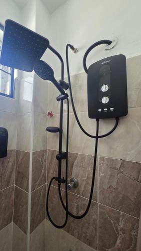 a blow dryer in a shower in a room at Seasalt & Sand in Mtwapa