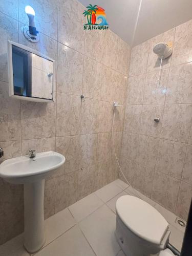 a bathroom with a toilet and a sink at Pousada NativaMar in Guaratuba