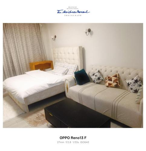 a bedroom with two beds and a couch at Quick Connect Studio Kileleshwa in Nairobi