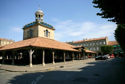 a building with a clock tower on top of it at Hôtel La Renaissance in Revel