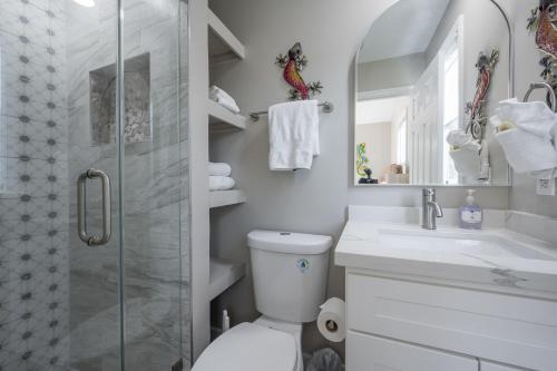 a bathroom with a shower and a toilet and a sink at ISLAND TIME ON THE GREEN in Key West