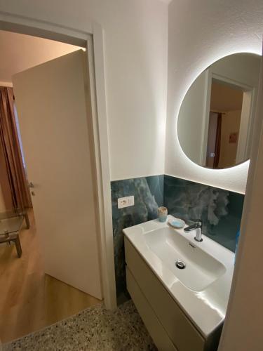 a bathroom with a sink and a mirror at Casa FATA MELANIA-free parking-self check in in Tavernerio