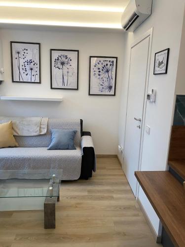 a bedroom with a bed and some pictures on the wall at Casa FATA MELANIA-free parking-self check in in Tavernerio