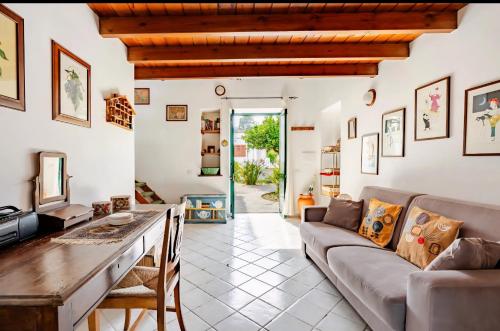 a living room with a couch and a table at Casa DAFNE in Lipari