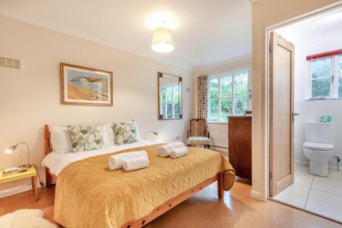 a bedroom with a large bed with two towels on it at 3 Bed in Worth Matravers oc-wy334 in Worth Matravers