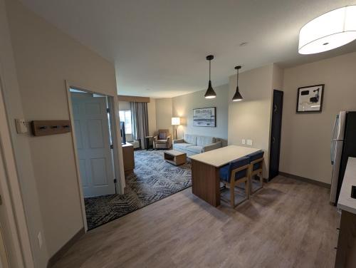 a living room with a table and a couch at Candlewood Suites Avondale-New Orleans by IHG in Avondale