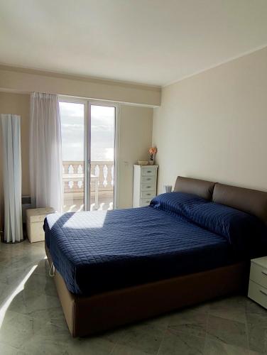 a bedroom with a bed and a large window at Victoria Plaza in Menton