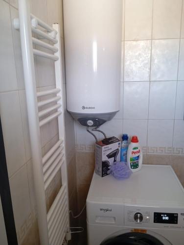 a small bathroom with a toilet and a white cabinet at Monfort Studio in Bansko