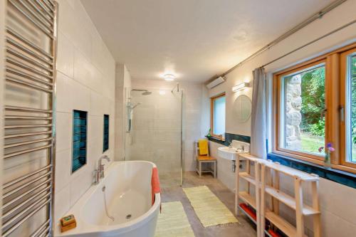 a bathroom with a tub and two sinks and a shower at 3 Bed in Dartington oc-b30033 in Darlington