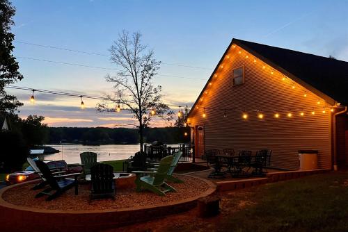 a building with chairs and tables and lights on it at Lakefront Suite Dock, No-Wake Cove & Firepit in Marion