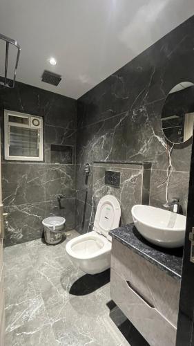 a bathroom with a toilet and a sink at Hotel City View in Golāghāt