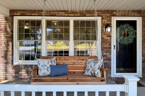 a bench on the front porch of a house at Walkable 2BR Cottage in Downtown Marion in Marion
