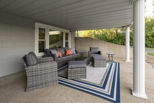 a patio with a couch and chairs and a table at Classic Lakeside Vacation Sleeps 9 in Marion
