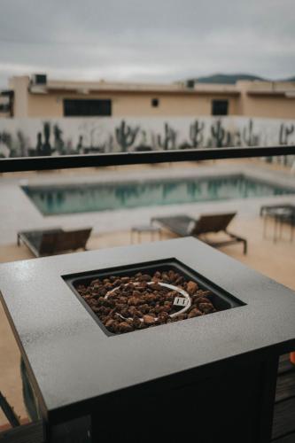 a tray of food on a table next to a pool at Casas VV in Valle de Guadalupe