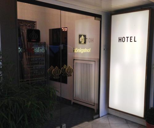 a reflection of a hotel sign on the side of a building at Hotel Königshof The Arthouse in Cologne