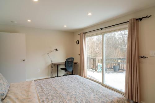 a bedroom with a bed and a large window at Bright, Spacious Home with Private Deck in Potomac