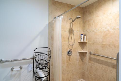 a bathroom with a shower with a shower curtain at Bright, Spacious Home with Private Deck in Potomac