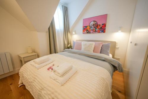 a bedroom with a bed with two towels on it at StayPoint in Eastbourne
