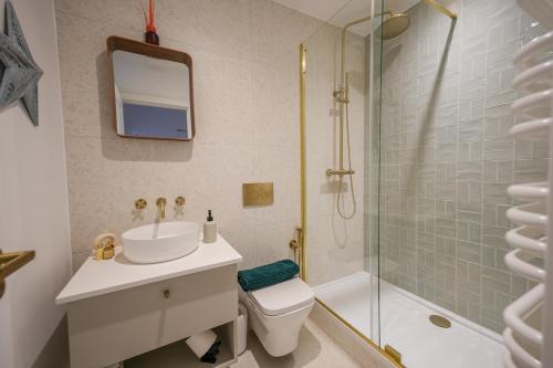 a bathroom with a sink and a toilet and a shower at StayPoint in Eastbourne