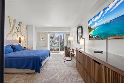 a bedroom with a blue bed and a large painting on the wall at Ala Moana Hotel _ Ocean view with balcony in Honolulu