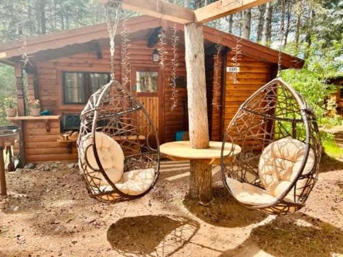 a cabin with two swings in front of a house at The Timberjack in Hayward