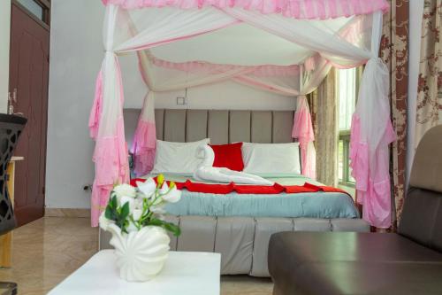 a bedroom with a bed with a canopy at The city Block Apartment in Bujumbura