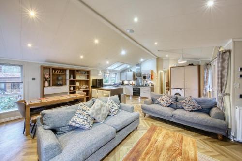 a living room with two couches and a kitchen at New Forest lodge - 194 NO PETS in Fordingbridge