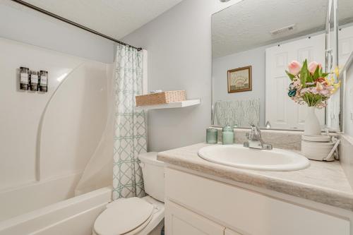 a white bathroom with a sink and a toilet at 7 Mi to Downtown Fun! Spacious Augusta Condo in Augusta