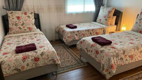 a room with two beds with cushions on them at Luxury 127m Apartment in Jardins de Carthage with Balcony, Private Parking & Prime Location in Sidi Daoud