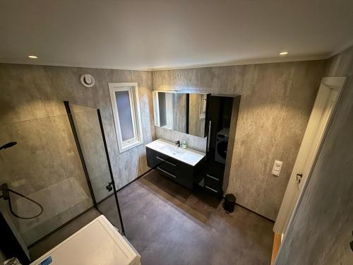 an overhead view of a bathroom with a sink and mirror at Langhaugen - Kabelvåg in Kabelvåg