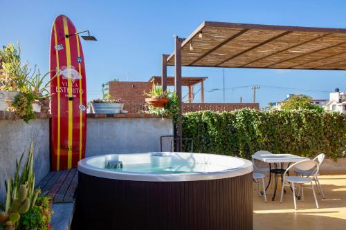 a hot tub on a patio with a surfboard at Villa Esterito - La Paz Baja California Sur in La Paz