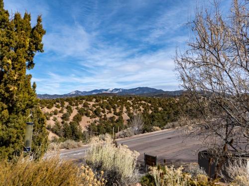 a road in the desert with mountains in the background at Artist Road #31 in Santa Fe